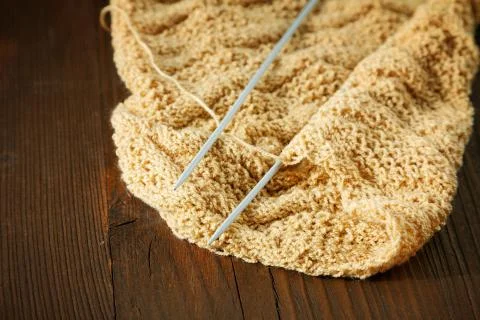 Knitting spokes with ball of wool on table Stock Photos