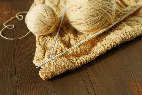 Knitting spokes with ball of wool on table Stock Photos