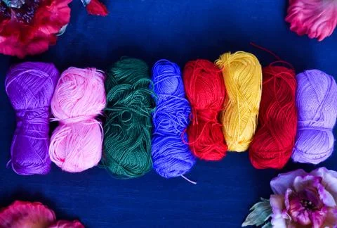 Knitting threads on a blue background Stock Photos