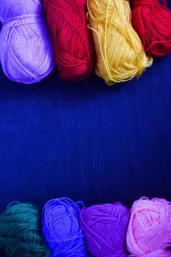 Knitting threads on a blue background Stock Photos