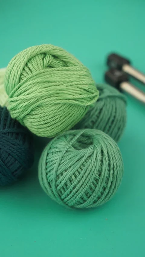 Knitting with vibrant green yarn in a creative space Video stock 315335220