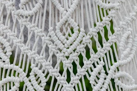 Knitting white threads net hand made craft pattern close up textile material Foto stock