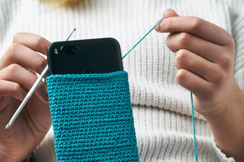 Knitting a woolen smartphone case Fotos de archivo
