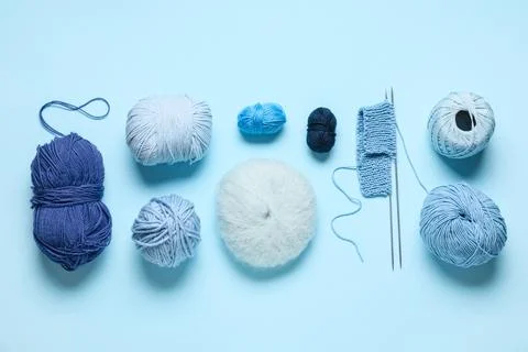 Knitting yarn with needles on blue background Stock Photos