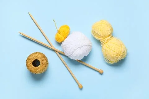 Knitting yarn with needles on blue background Stock Photos