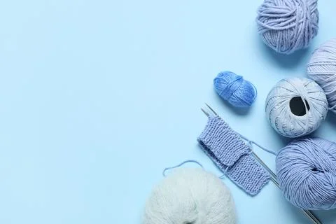 Knitting yarn with needles on blue background Stock Photos