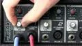 Knob turn & cable plug in; powered audio mixer HD Footage