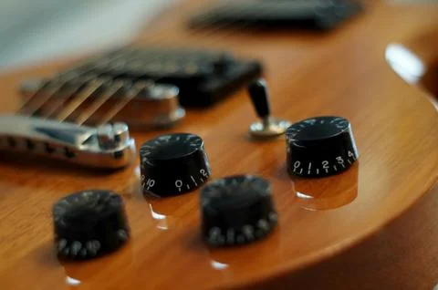 Knobs and buttons - Closeup shot of Washburn Idol WI-64 electric guitar with Stock Photos