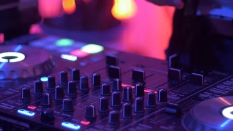 Knobs and sliders being adjusted on DJ on turntable mixer with warm 動画素材 234444460