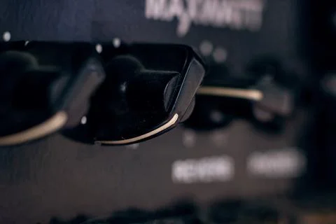 Knobs on Guitar Amplifier closeup, macro photo 库存照片