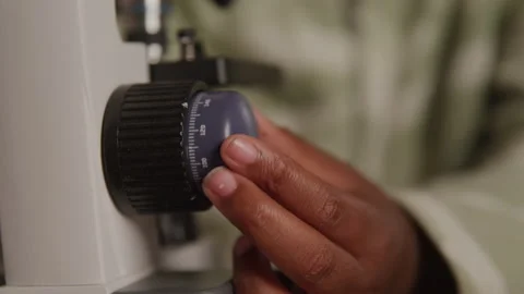 Knobs on a Microscope Being Turned by a Young Girl 스톡 동영상 208796655