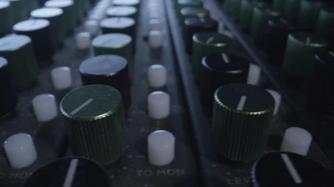 Knobs on a professional music producer mixer Stock Footage 128395987