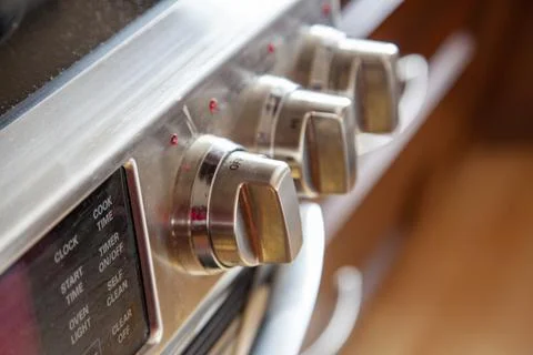 Knobs on a stainless steel stove Stock Photos