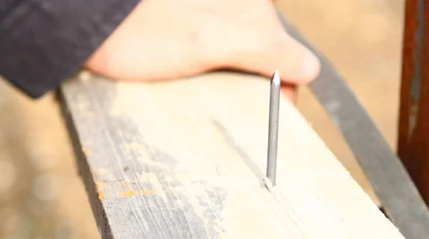 Knock a nail from a board closeup Stock Footage 49941474