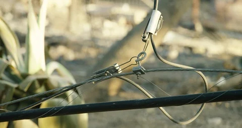 Knocked down telephone pole wire after the Woolsey Fire - 2018 Stock Footage 98953401
