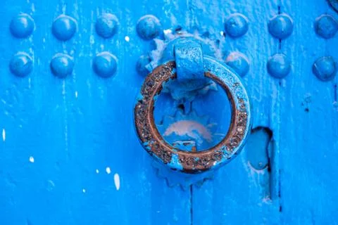 Knocker on a blue door Stock Photos