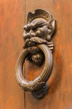 Knocker in the shape of head of a man with a mustache Stock Photos