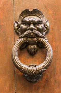 Knocker in the shape of head of a man with a mustache Stock Photos