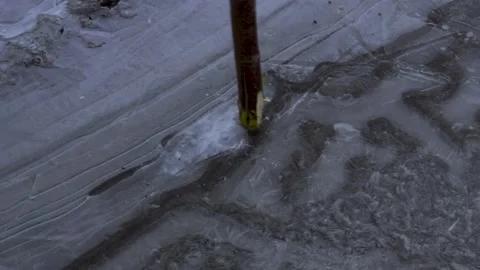 Knocking out ice in the cold. Stock Footage 230408135