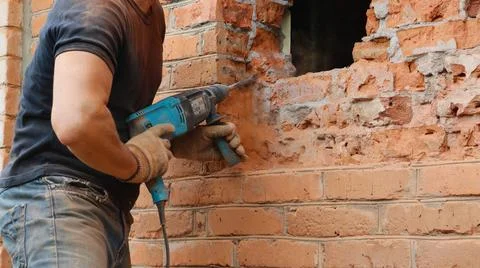 Knocking out a window opening with a pneumatic drill Stock Photos