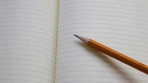 Knocking a pencil on notebook or copybook. beating the rhythm. Stock Footage 106719827