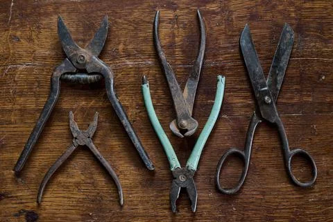 Knoling with old and rusty tools on a vintage table made of lacquered wood Stock Photos