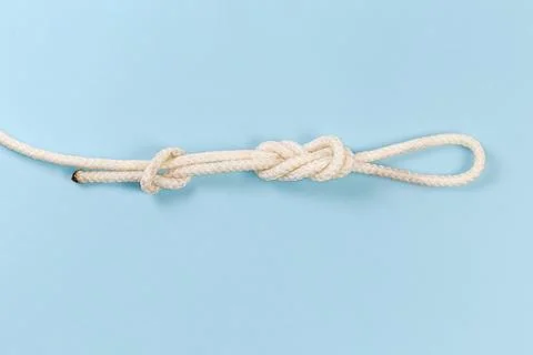 Knot ?igure-eight loop with stopper knot on blue background Stock Photos