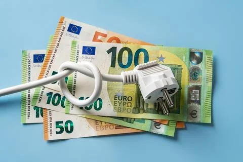 Knotted power cable with electric plug on 50 and 100 euro banknotes. Stock Photos