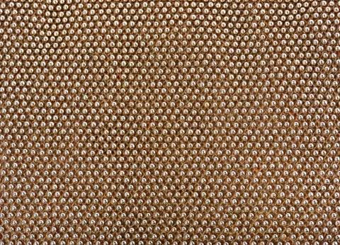 Knotted surface with metal knobs Foto stock