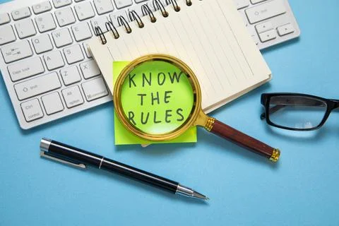 Know The Rules on sticky note on the blue background. Stock Photos
