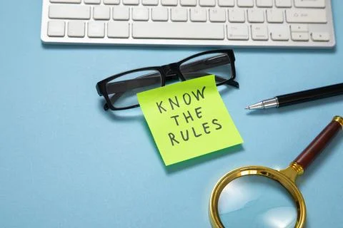 Know The Rules on sticky note on the blue background. Stock Photos