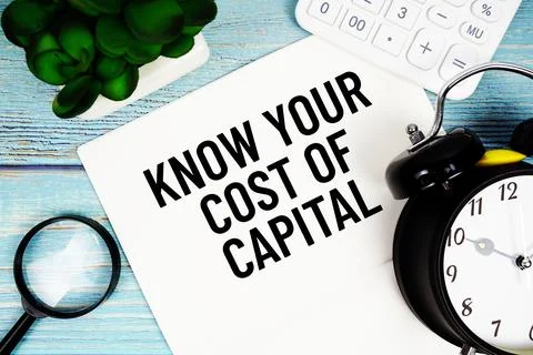 Know Your Cost Of Capital message written on paper placed on a blue wooden .. Stock Photos