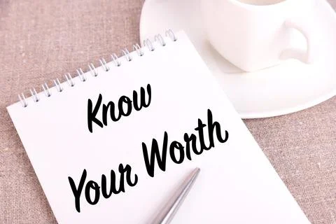 Know your worth, the text is written in a notebook lying on a linen canvas an Stock Photos