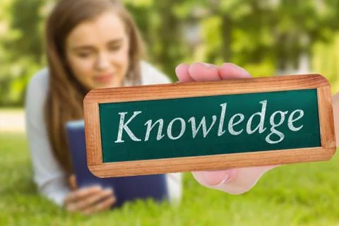 Knowledge against university student lying and using tablet pc Stock Photos