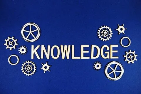 Knowledge alphabet letters with gears element on navy blue background Stockfoto's