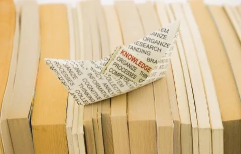 Knowledge boat on books Stock Photos