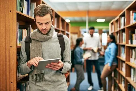 Knowledge can stem from many places. a university student using a digital tablet Stock Photos