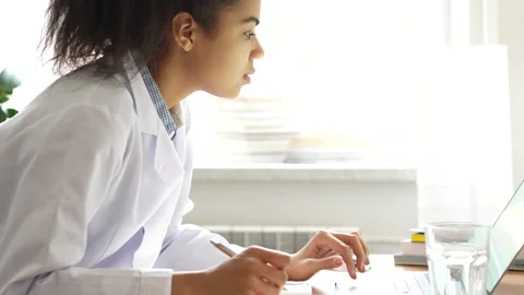 Knowledge. Close up of young mixed race girl, medical student making notes while Stock Footage 145791503