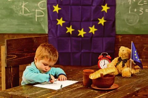 Knowledge concept. Child draw at table with eu flag on class chalkboard Stock Photos