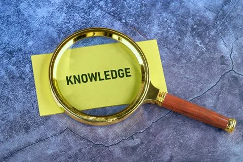 Knowledge Concept: Magnifying Glass Over Text Photos