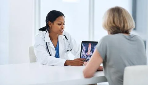 Knowledge is the cure. a young doctor using a digital tablet during a Stock Photos