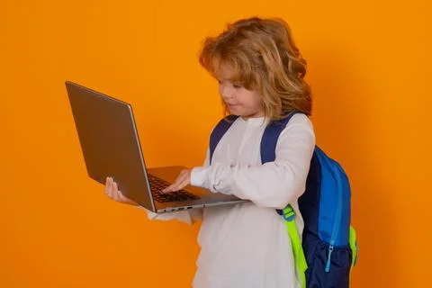 Knowledge day. School boy using laptop computer. Smart caucasian school boy kid Stock Photos