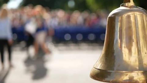 Knowledge day at school golden school bell waving in the foreground close-up Stock Footage 160410400
