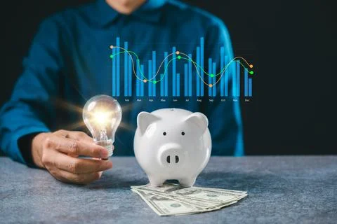 Knowledge fuels financial innovation using glowing lightbulb held by hand b.. Stock Photos