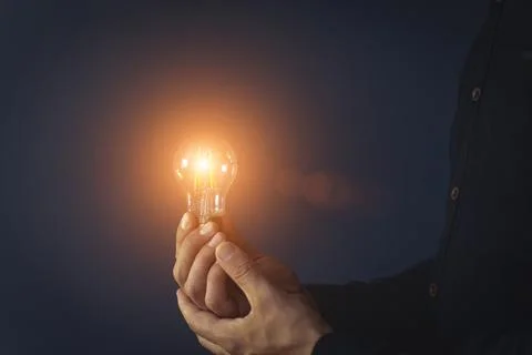 Knowledge idea bulb concept. Electric light bulb in hand business manager Stock Photos