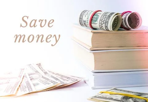 Knowledge leads to wealth. Stack of books with dollars. Concept of expensive  Foto stock