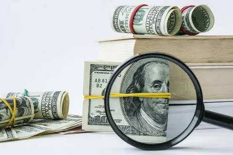 Knowledge leads to wealth. Stack of books with dollars. Concept of expensi... 스톡 사진