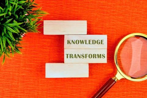 KNOWLEDGE TRANSFORMS concept words assembled from wooden blocks in composit.. Stock Photos
