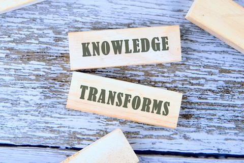 KNOWLEDGE TRANSFORMS concept words is assembled from blocks on wooden boards Stock Photos