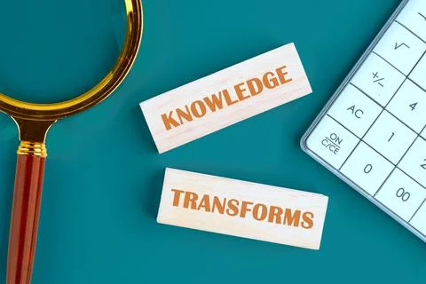 KNOWLEDGE TRANSFORMS concept words made of wooden blocks on a green background Stock Photos